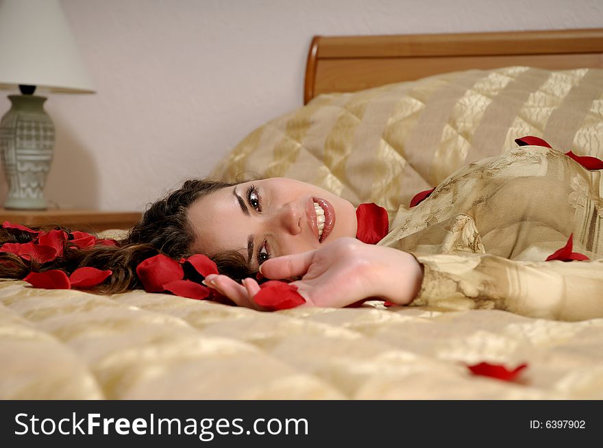 Beautiful smiling woman with red rose petals. Beautiful smiling woman with red rose petals