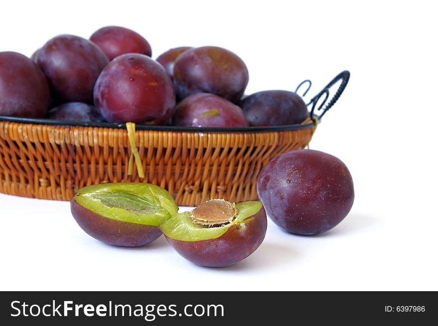 Basket with plum isolated on a white background