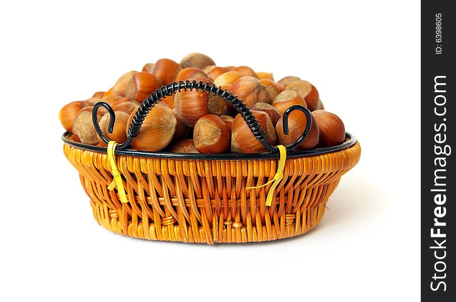 Wood nuts in a basket isolated on a white background. Wood nuts in a basket isolated on a white background