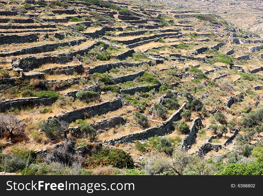 Terraces on the slopes of the arid landscape of the island of Tinos, Greece. Terraces on the slopes of the arid landscape of the island of Tinos, Greece