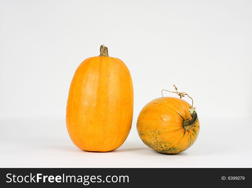 Two pumpkins against white background
