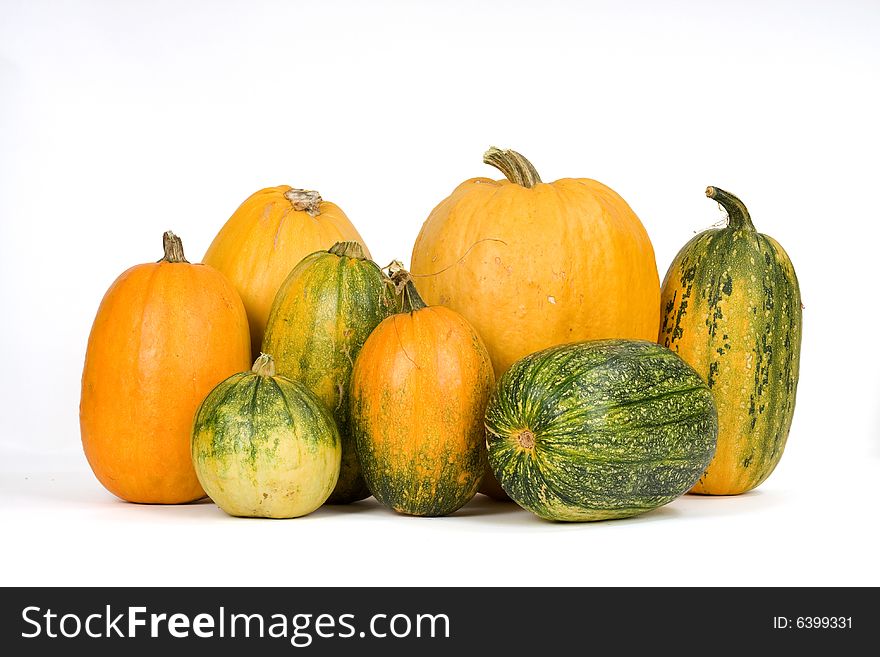 Orange and green pumpkins against white background