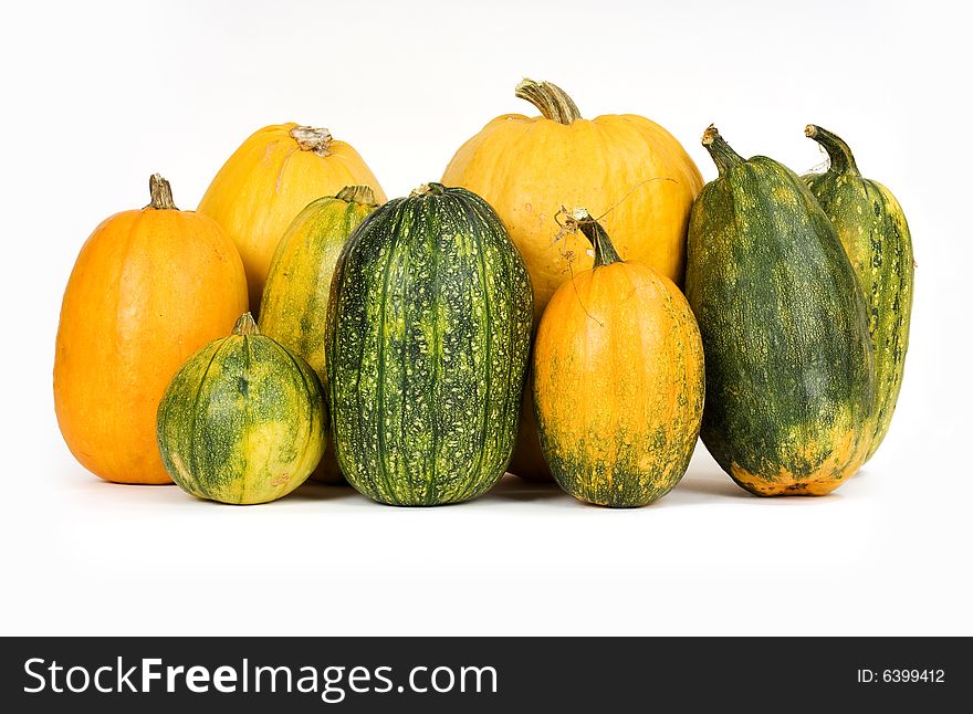 Orange and green pumpkins against white background