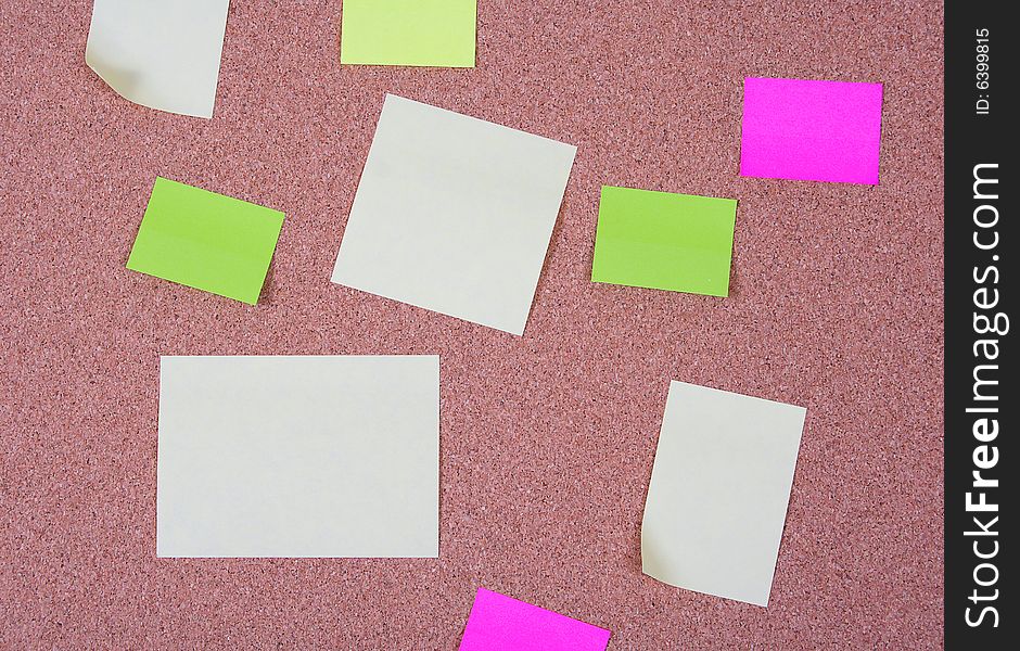 Pieces of note paper on a cork bulletin board