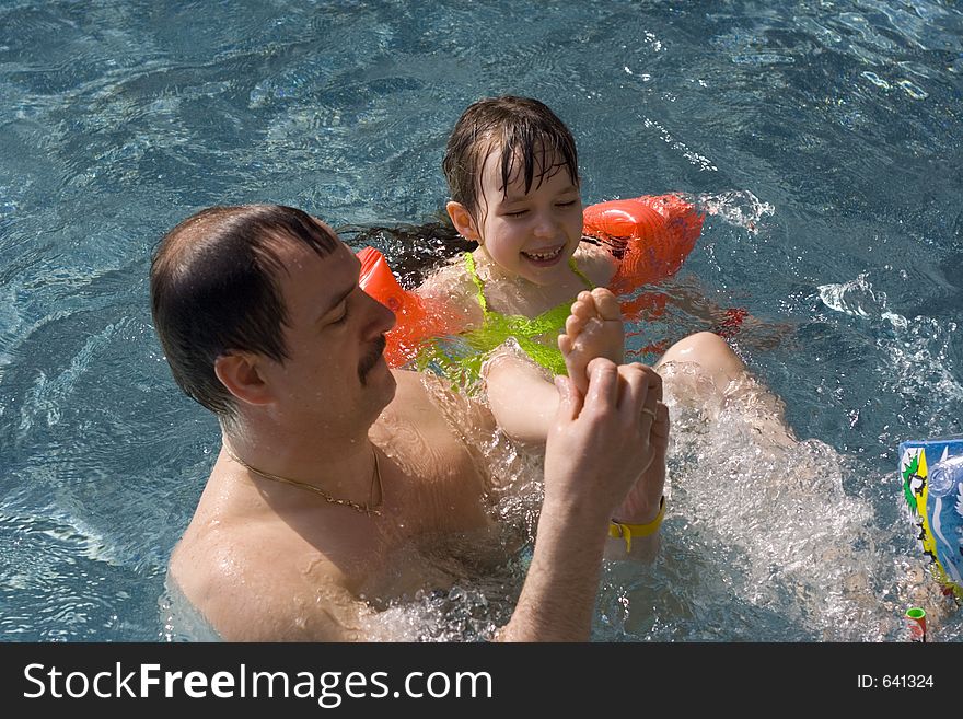 Fun with father in swimming-pool