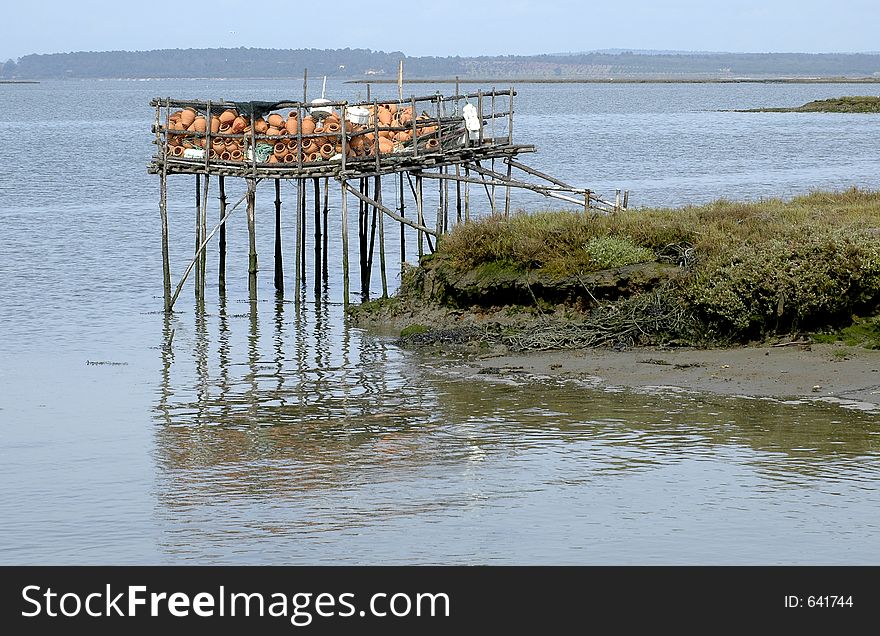 Fishermen equipment. Octopus traps at fishermen palaffite village. Estuary of Sado River, Carrasqueira, southern Portugal, E.U. Fishermen equipment. Octopus traps at fishermen palaffite village. Estuary of Sado River, Carrasqueira, southern Portugal, E.U.