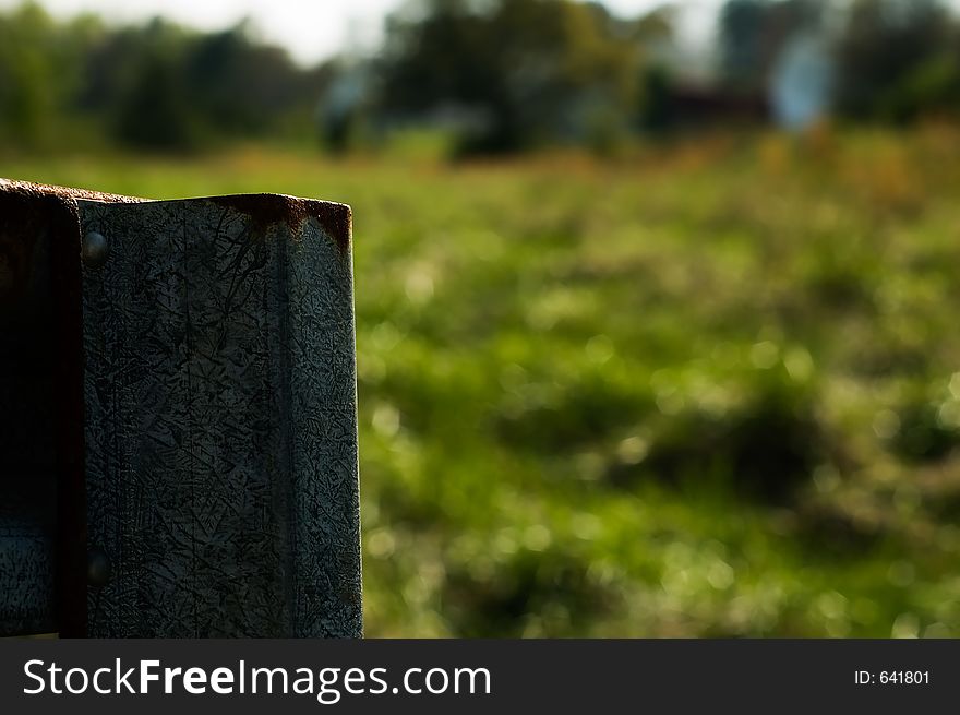 Galvanized metal fence in a country field. Galvanized metal fence in a country field