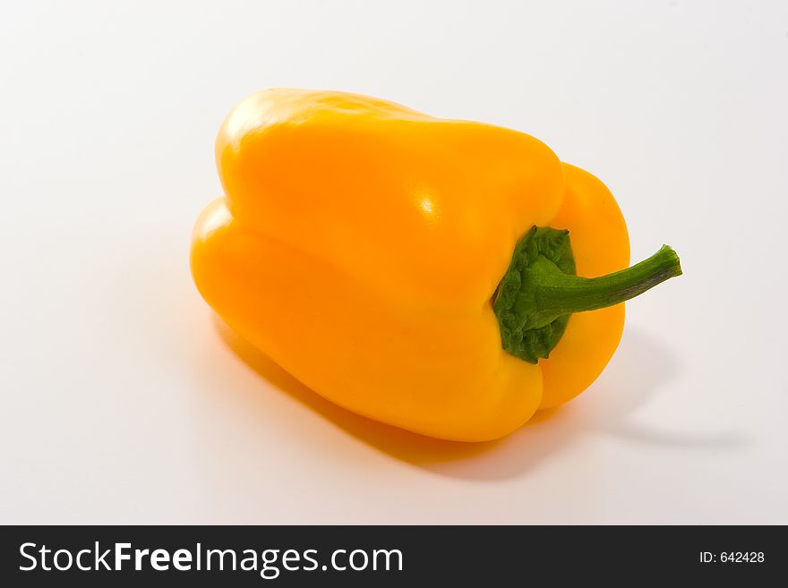 Studio work, yellow pepper on white table. Studio work, yellow pepper on white table