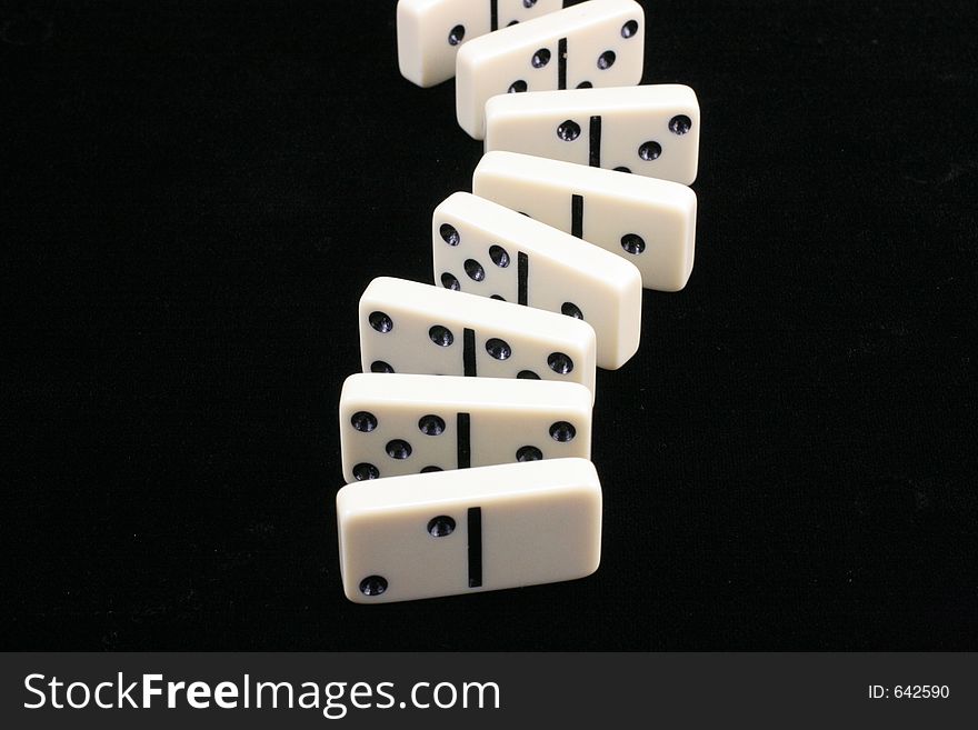 Roll of dominoes on a black background. Roll of dominoes on a black background.