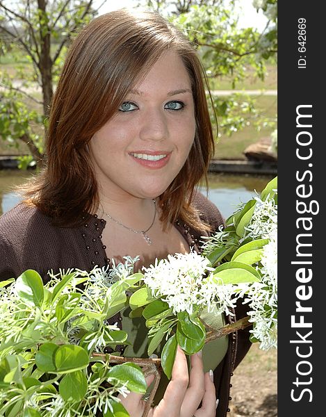 Teenage girl poses with some flowers. Teenage girl poses with some flowers.