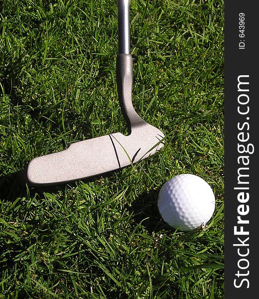 Golf putter and ball on grass. Golf putter and ball on grass