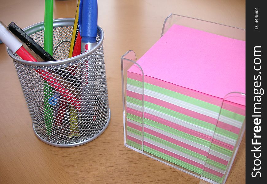 Note paper and desktidy on a desk. Note paper and desktidy on a desk