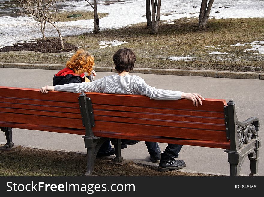 Spring song on bench in park