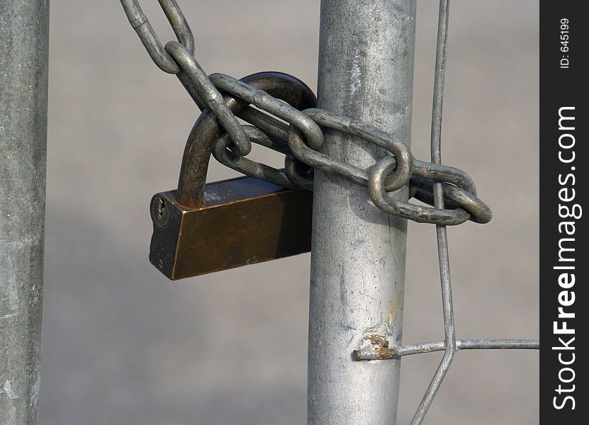 Close up of a large lock and chain securing an urban building. Close up of a large lock and chain securing an urban building