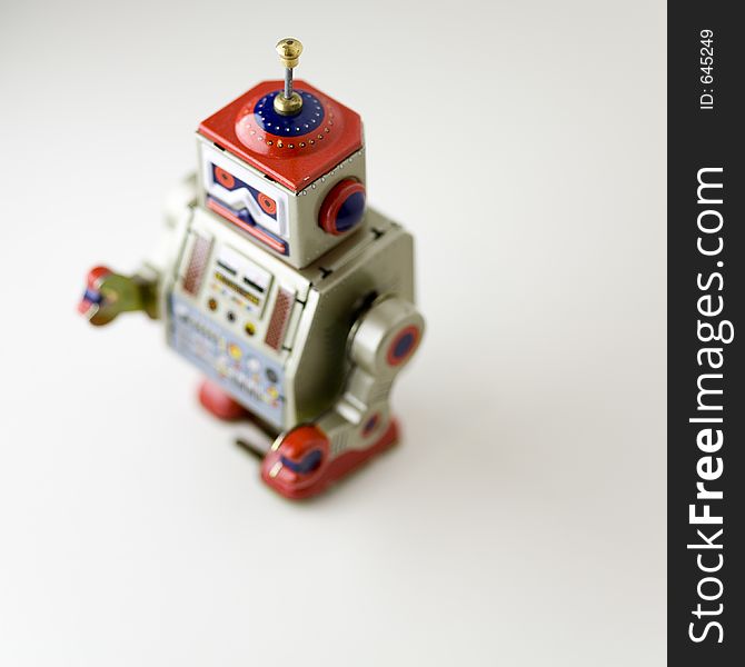 Toy metal robot walking towards its key