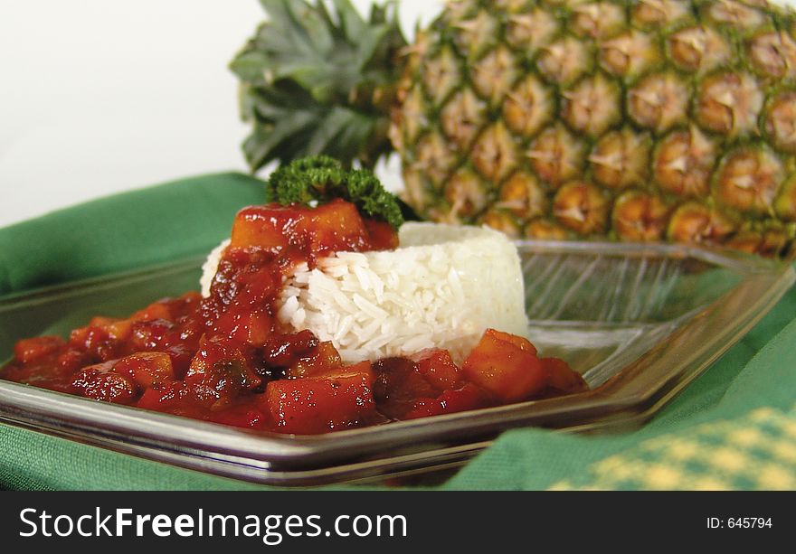 Sweet sour sauce with pineapple, raisins and pickled cherries with focus on sauce. Sweet sour sauce with pineapple, raisins and pickled cherries with focus on sauce