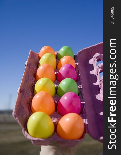 A dozon easter eggs in an egg carton