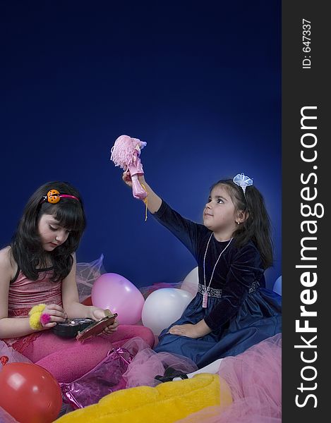 Two little girls playing with dolls and make-up. Two little girls playing with dolls and make-up