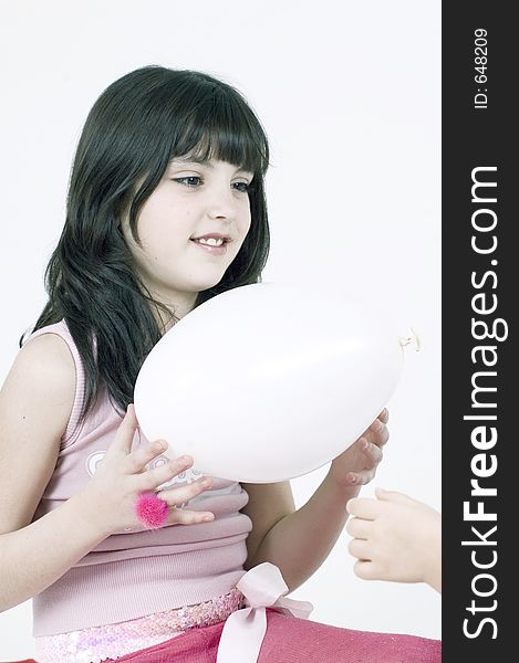 Pretty little girl playing with a white balloon. Pretty little girl playing with a white balloon