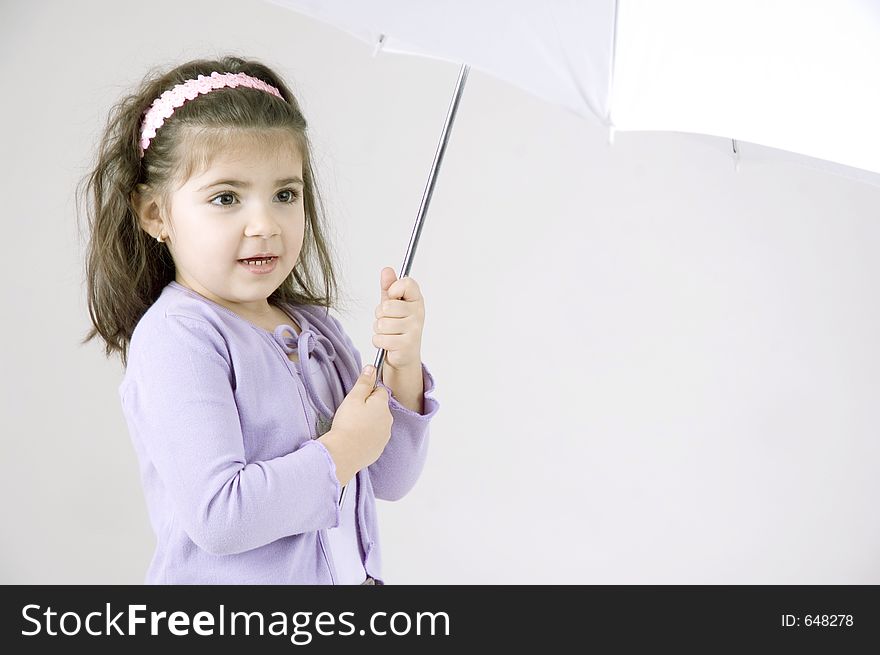 Cute little girl holding an umbrella waiting for the rain to come. Cute little girl holding an umbrella waiting for the rain to come.