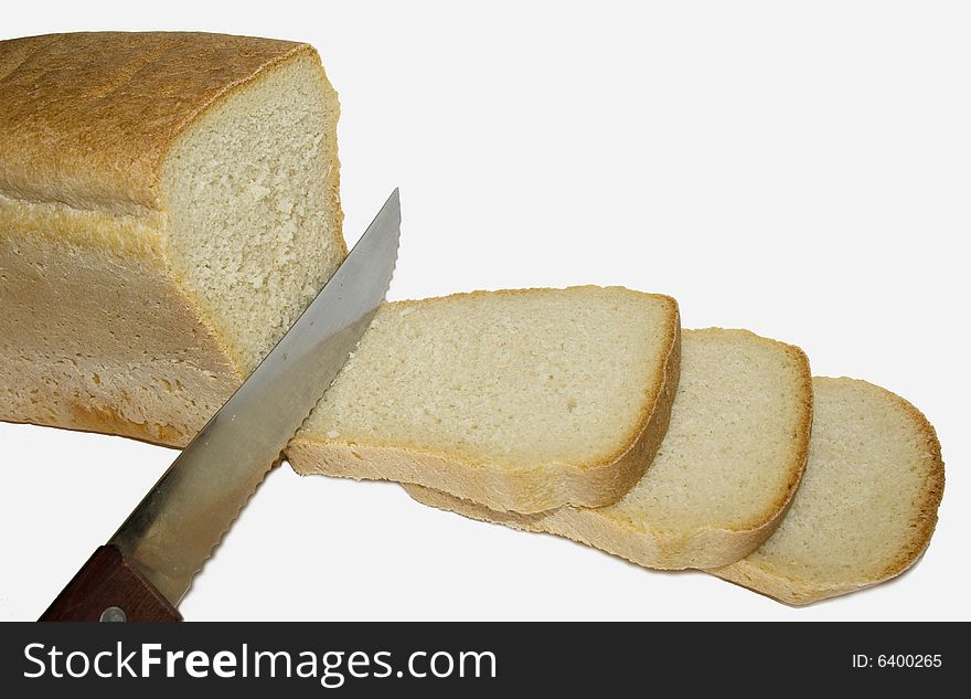 Knife from a steel cut bread on some slices. Knife from a steel cut bread on some slices