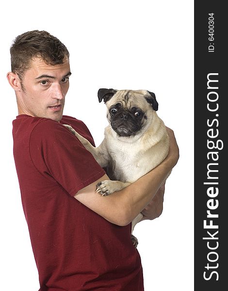 A man holds a scared looking pug dog in his arms. A man holds a scared looking pug dog in his arms