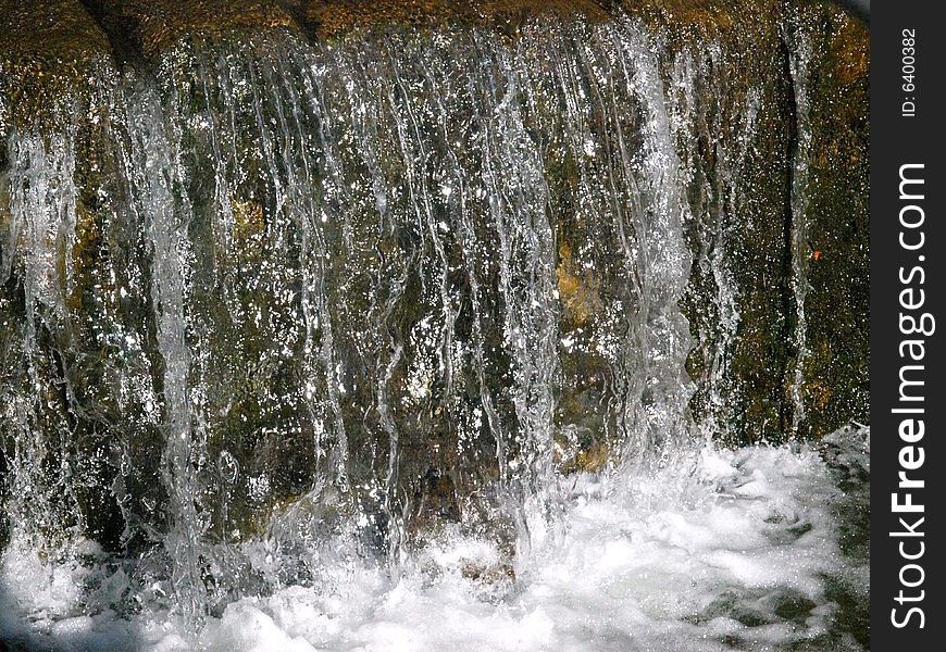 A beautiful shot of a mountain's waterfall. A beautiful shot of a mountain's waterfall