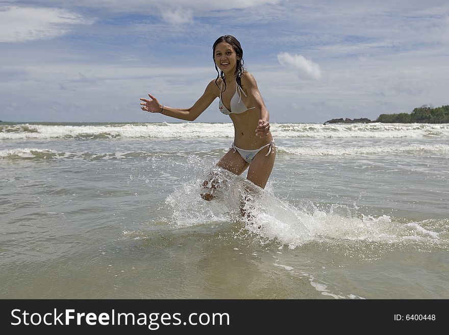 Female Teenager Jumps On The Beach