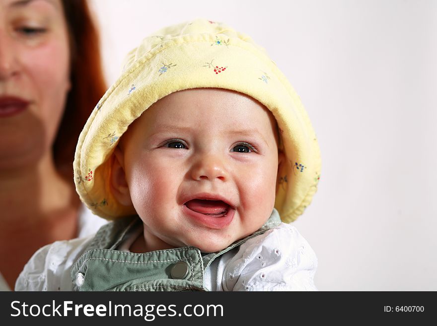 A woman with happy baby in her hands. A woman with happy baby in her hands