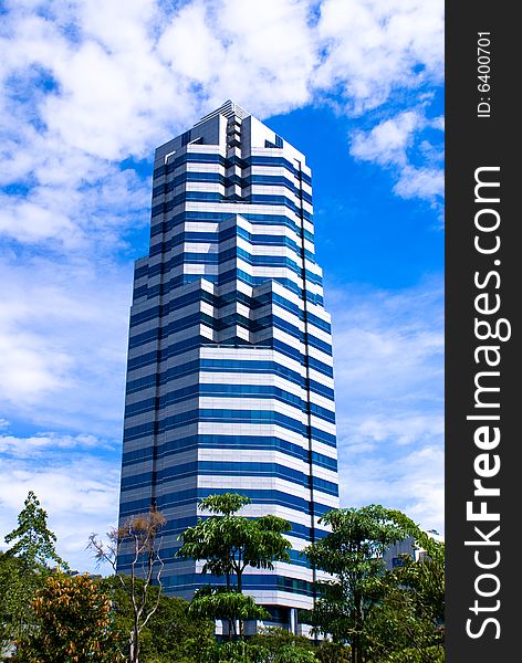Modern single commercial building against blue sky. Modern single commercial building against blue sky
