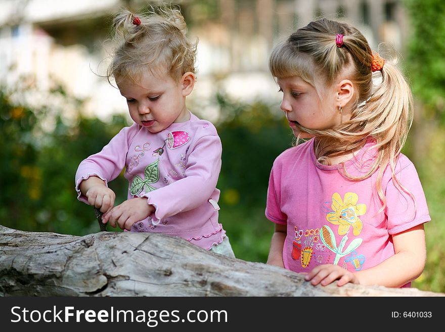 An image of two children playing outdoor. An image of two children playing outdoor