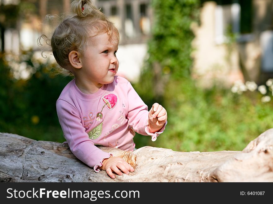 An image of little baby-girl playing outdoor. An image of little baby-girl playing outdoor