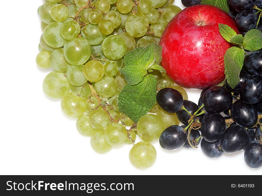 Green and red grapes and apple isolated