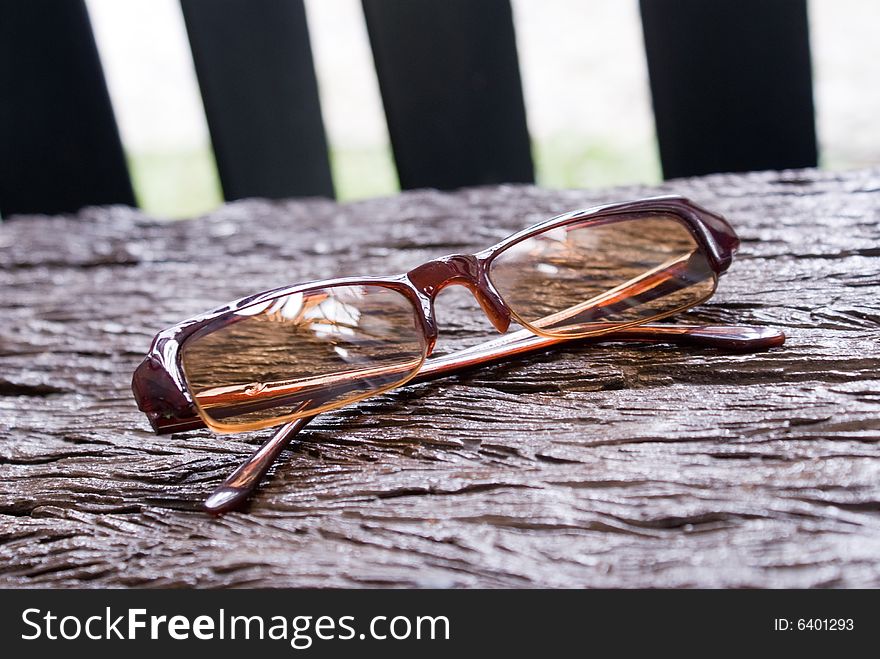 Brown classical sun glass on wooden chair