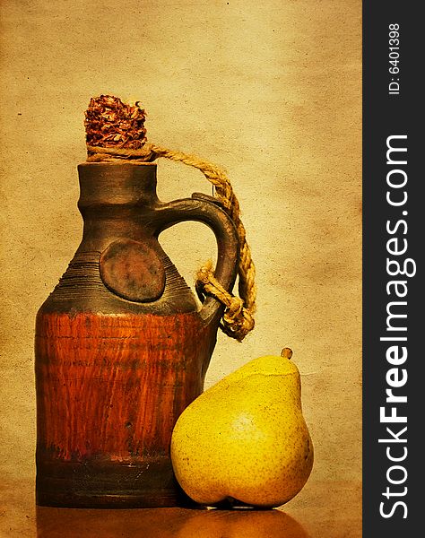 Autumn still life with ceramic bottle and pear