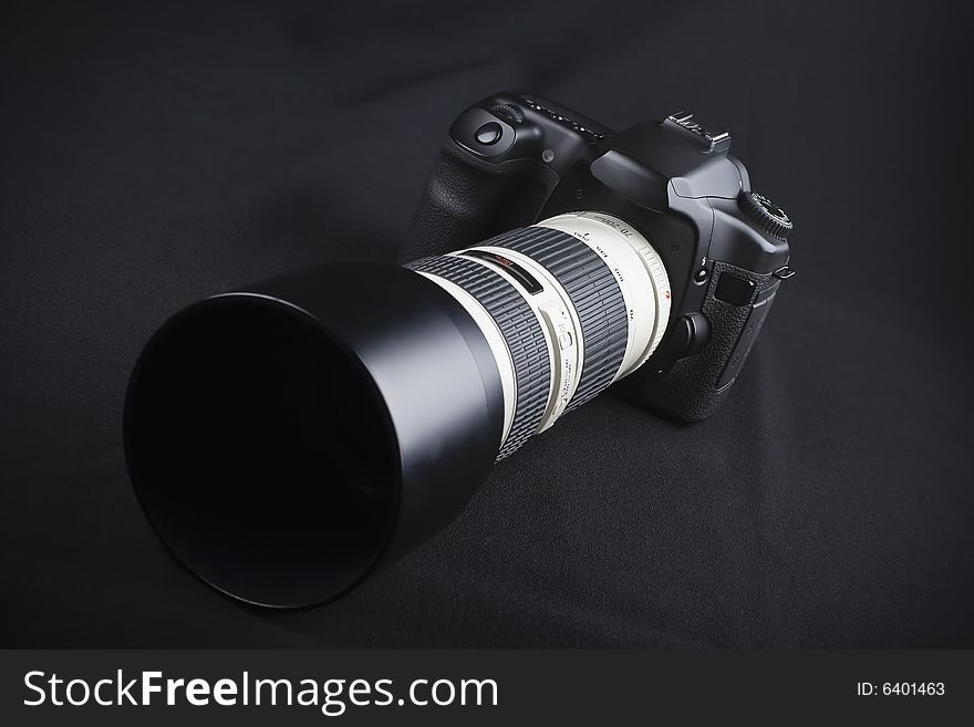 Professional digital photo camera with zoom lens on black background. Professional digital photo camera with zoom lens on black background