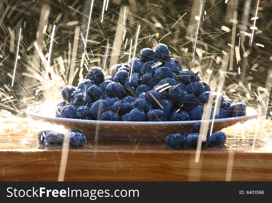 Blueberry on a plate in raindrops