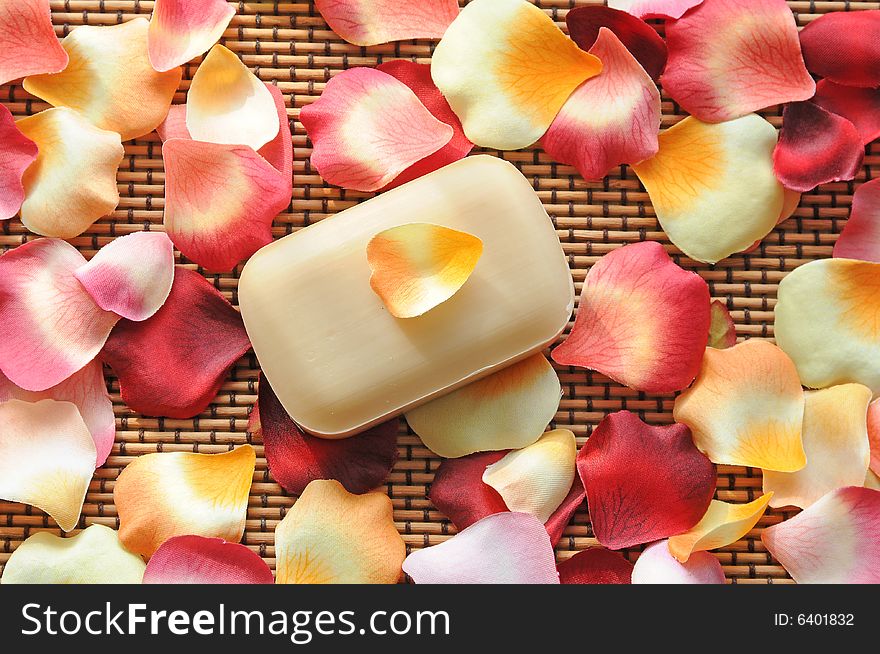 Red and yellow flower petals and a piece of soap. Red and yellow flower petals and a piece of soap.