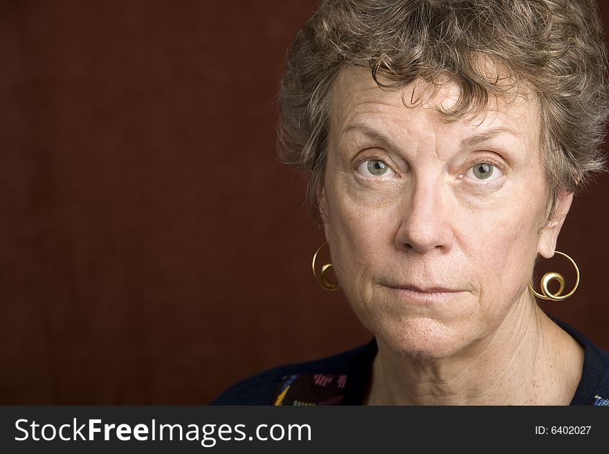 Portrait of a smiling senior woman in an embroidered shirt. Portrait of a smiling senior woman in an embroidered shirt