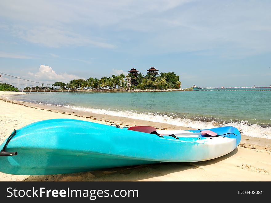 Tropical destination Sentosa Island Beach with a canoe