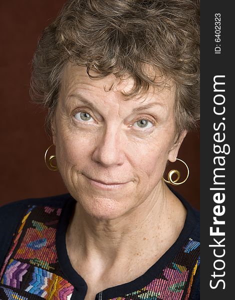 Portrait of a smiling senior woman in an embroidered shirt. Portrait of a smiling senior woman in an embroidered shirt