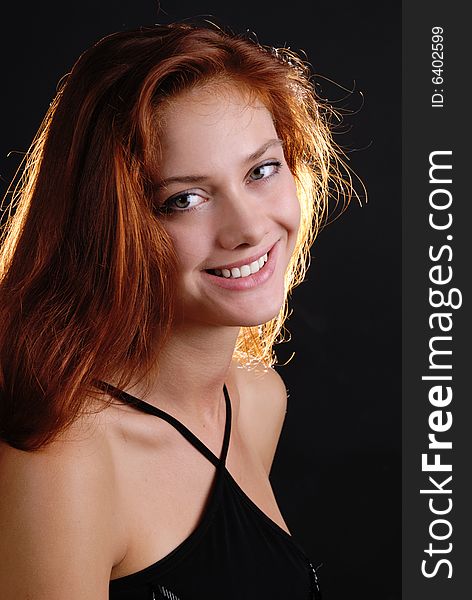 Beautiful smiling girl on black background