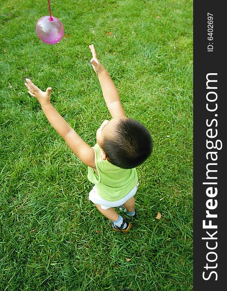 Baby playing on lawn