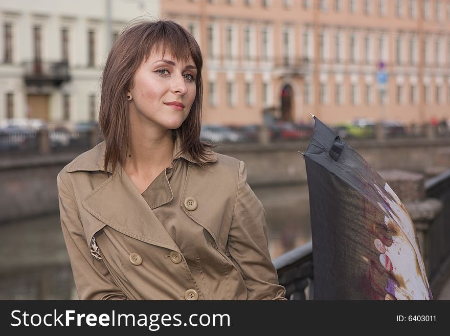 Portrait of a young beautiful woman with umbrella