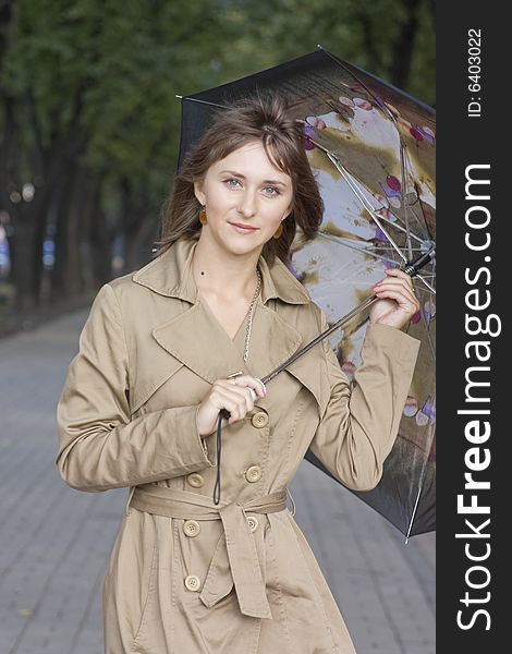 Portrait of a young beautiful woman with umbrella