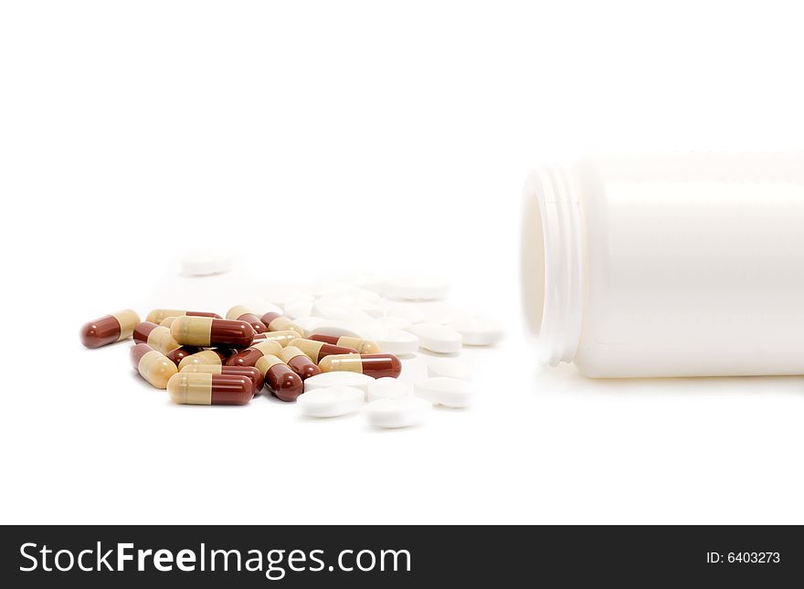 Medicine's pills over white background