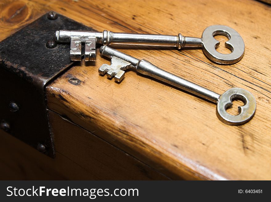 Antique door keys on a wooden surface