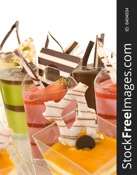 An assortment of colorful mousse desserts in cups. An assortment of colorful mousse desserts in cups.