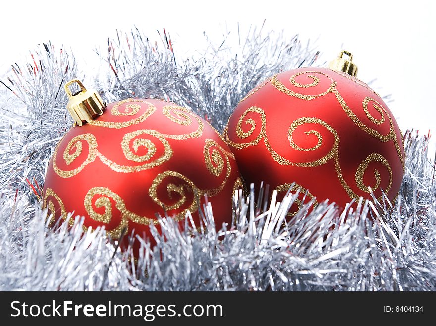 Two christmas balls with tinsel isolated on white background