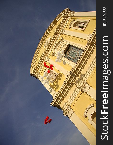 Red and white balloons floating skyward